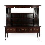 A George III Oak Dresser and Rack, late 18th century, the upper section with a bold cornice above