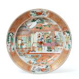 A Chinese Porcelain Charger, Yongzheng, painted in famille rose enamels with figures on a veranda