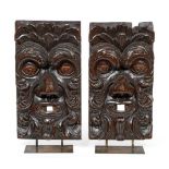 A Pair of Venetian Carved Pine Wall Masks, 18th century, each worked in high relief as a Green