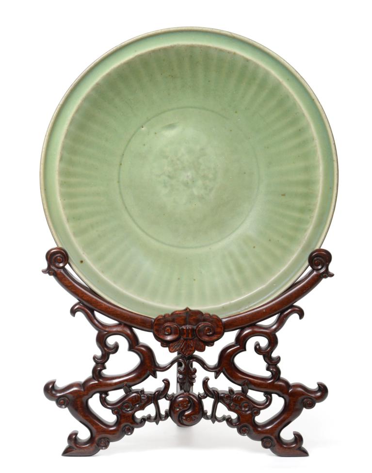 A Longquan Celadon Dish, Ming dynasty, carved with a central foliate panel within a broad fluted