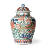 A Chinese Wucai Porcelain Baluster Jar and Cover, 17th century, painted with mythical beasts amongst