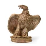 A Terracotta Model of a Florentine Eagle, perched, wings partially outstretched, on an oval