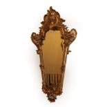 A Mid 19th Century French Gilt and Gesso Wall Mirror, the bevelled glass plate within a moulded