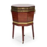 A George III Mahogany and Brass Bound Octagonal Cellaret, circa 1800, the hinged lid enclosing a