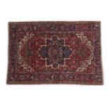 Heriz Rug North West Iran, circa 1920 The blood red field of stylised flowers and leaves around an