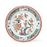A Chinese Porcelain Charger, Kangxi, painted in famille verte enamels with a birds amongst flowering