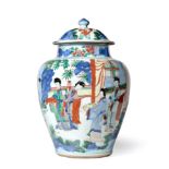 A Chinese Wucai Porcelain Jar and Cover, mid 17th century, of baluster form, painted with figures in