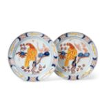 A Pair of Dutch Delft Pancake Plates, 18th century, painted in colour with parrots perched in