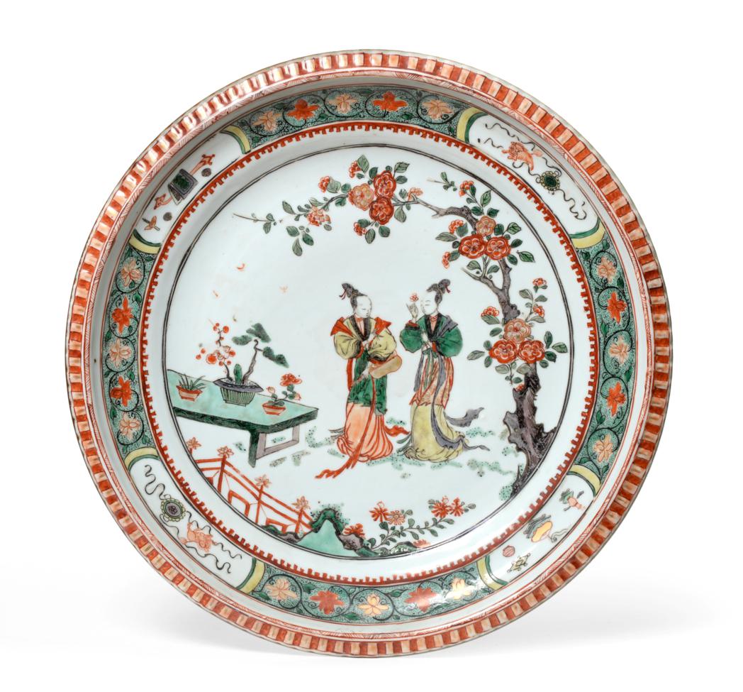 A Chinese Porcelain Charger, Kangxi, painted in famille verte enamels with figures in a fenced