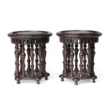 A Pair of Chinese Hardwood Pedestals, Qing Dynasty, probably 18th century, with circular top over an