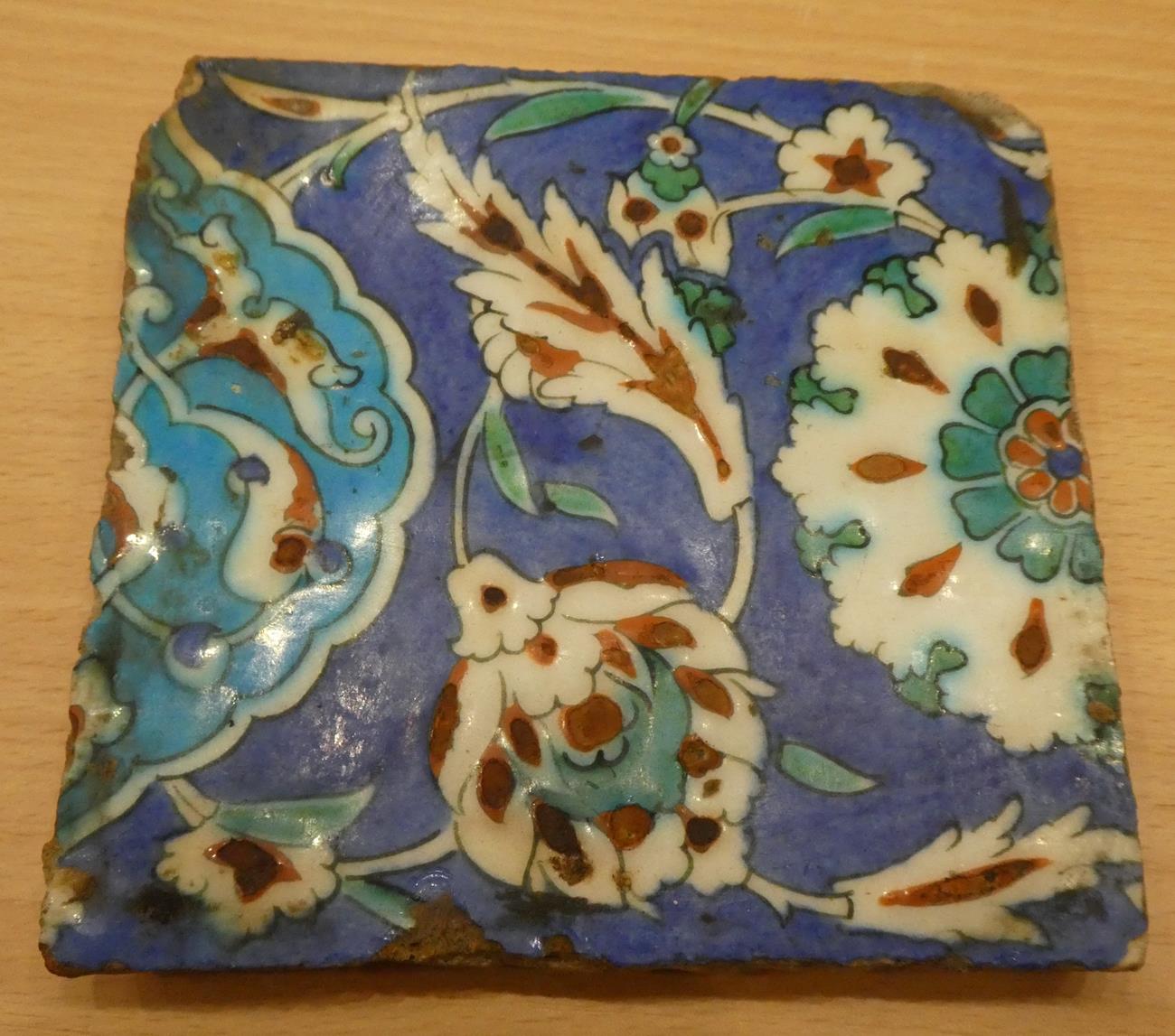 An Isnik Pottery Tile, circa 1580, typically painted in red, green, turquoise and blue with stylised - Image 3 of 3