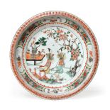 A Chinese Porcelain Charger, Kangxi, painted in famille verte enamels with figures in a fenced