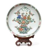 A Chinese Porcelain Dish, Kangxi, painted in famille verte enamels with a basket of flowers within a