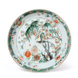 A Chinese Porcelain Charger, Kangxi, painted in famille verte enamels with a bird perched in a