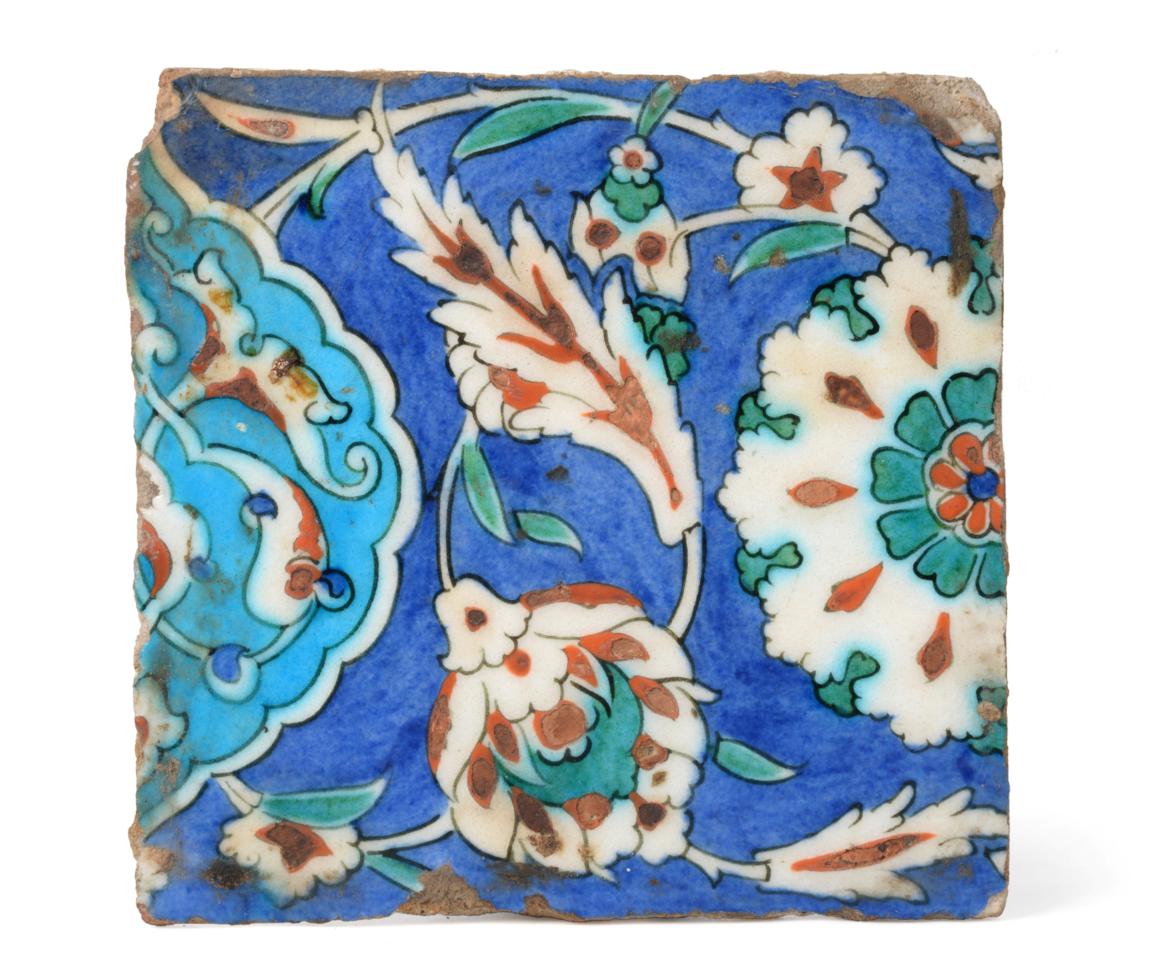 An Isnik Pottery Tile, circa 1580, typically painted in red, green, turquoise and blue with stylised