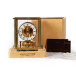 A Brass and Marble Atmos Clock, signed Jaeger LeCoultre, circa 1985, four glass panels with fluted