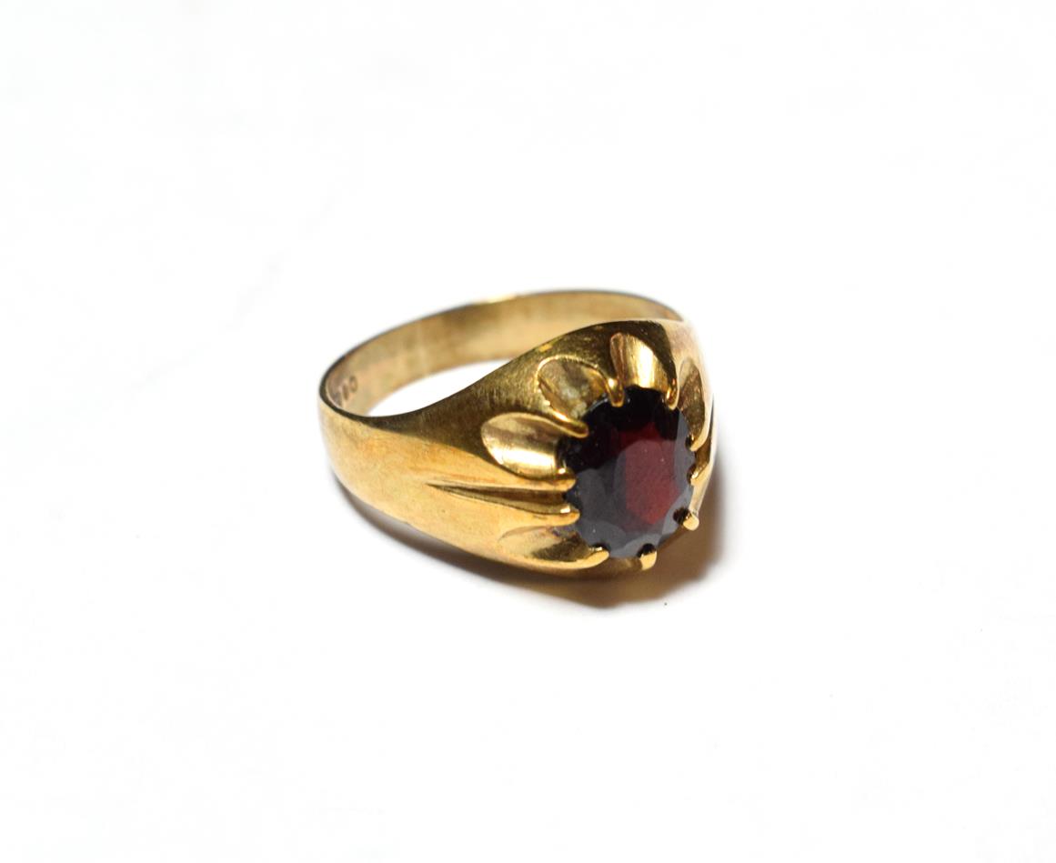 A 9 carat gold garnet solitaire ring, finger size R. Gross weight 4.1 grams.