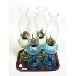 Two pairs of coloured glass oil lamps