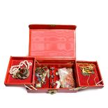 A red jewellery box containing miscellaneous jewellery including a Scottish paste set Celtic