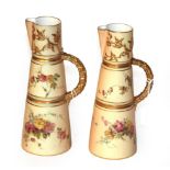 A matched pair of Royal Worcester blush Ivory painted and gilt decorated water jugs, pattern no -