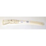 An early 20th century carved walrus tusk as a letter opener