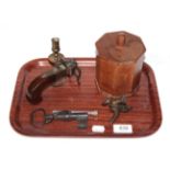 A tray of miscellaneous items, including a pistol form table lighter, a key (drilled as a pistol)