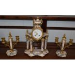 A French marble striking portico mantel clock with garniture