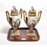 A pair of German porcelain urns and covers decorated with courting couples