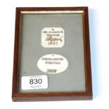 Two framed ivory labels engraved ''Her Majesty's Theatre 1857'', framed