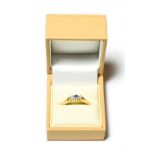 A 9 carat gold sapphire and diamond three stone ring, finger size N . Gross weight 2.7 grams.