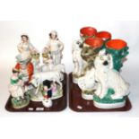 Two trays of 19th century Staffordshire flat back figures, spill vases and Toby jugs, figures etc