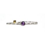An amethyst and diamond bracelet, a round cut amethyst in a white claw setting, to tapering gate