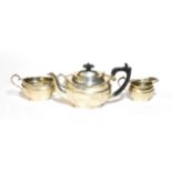 A silver three piece tea service