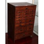 Late 19th/early 20th century printing shop contents: A stained pine miniature chest, with multiple