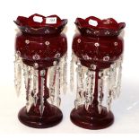 A pair of ruby glass table lustres, circa 1890, with castellated rim, painted foliate bands and