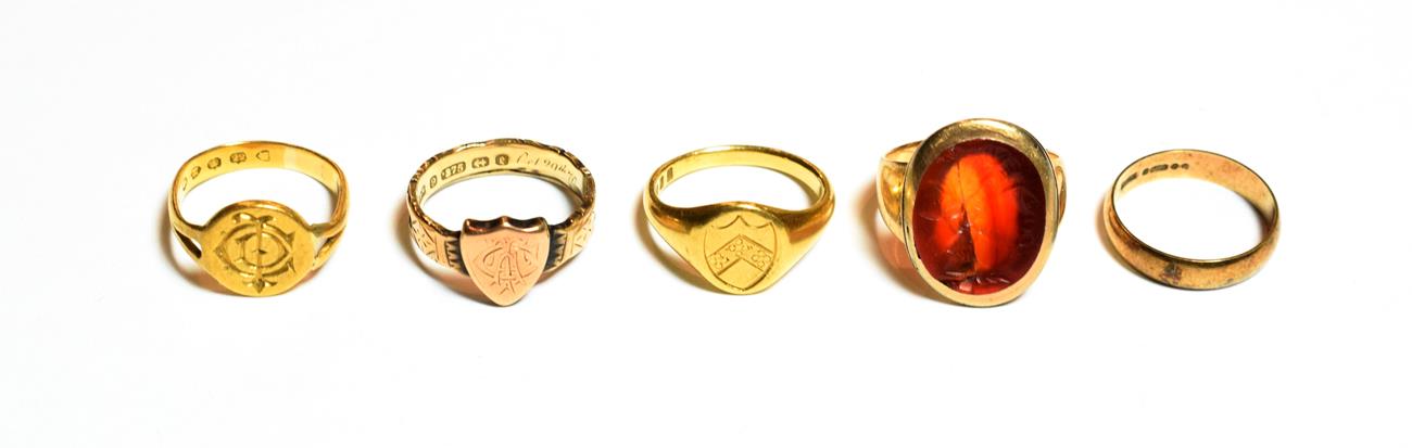 A 22 carat gold signet ring, out of shape; an 18 carat gold signet ring, finger size L; a 9 carat