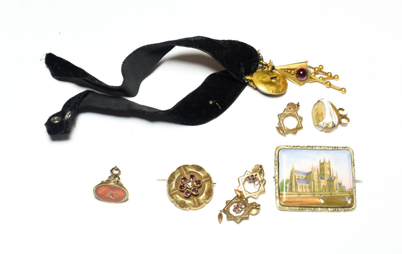 A collection of jewellery including a Victorian cabochon garnet pendant; a pair of yellow metal star