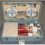 A cased 1950's-1960's three-person Sirram picnic hamper containing sandwich plates, knives &