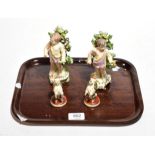 A pair of Sampson of Paris bocage figures; together with a pair of Sampson of Paris figures of dogs,