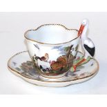 A 20th century Meissen hand painted tea cup and saucer decorated with chickens and insects and