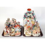 Two trays of 19th century Staffordshire flat back figures, spill vases and a pocket watch stand