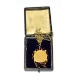 An Edwardian garnet locket on a 9 carat gold chain, drop length 5.8cm, chain length 51.5cm .
