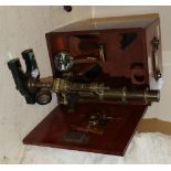 A French brass microscope together with an associated case and a kaleidoscope