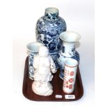 Chinese porcelain comprising a blanc de chine figure of Buddah, three various blue and white