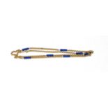 A 9 carat gold fancy link chain with lapis lazuli spacers, length 73.5cm . Gross weight 14.1 grams.