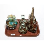 A collection of Mdina glass comprising a pair of bottle vases, a matching pair of glass paperweights