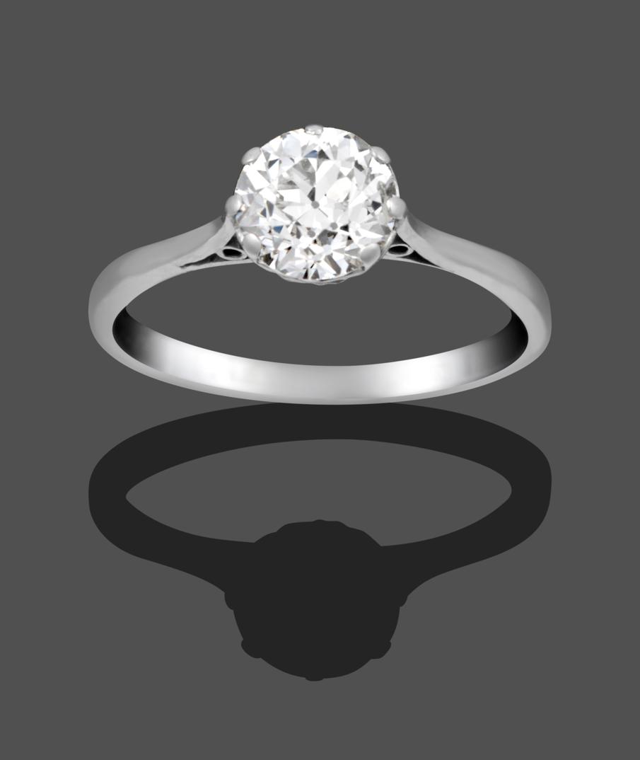 A Diamond Solitaire Ring, the old cut diamond in a white claw setting on a tapered shoulder plain