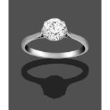 A Diamond Solitaire Ring, the old cut diamond in a white claw setting on a tapered shoulder plain