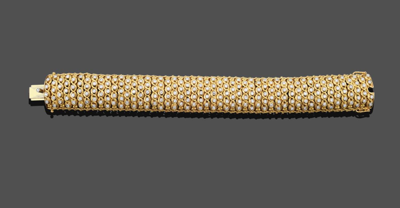 A Diamond Bracelet, the yellow broad fancy link bracelet set throughout with alternating columns