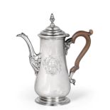 A George II Silver Coffee-Pot, by Francis Crump, London, 1743, pear-shaped and on spreading foot,